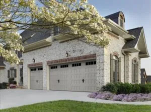 HillCrest sandtone color recessed panel garage door with Thames windows